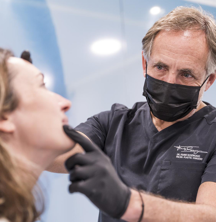 Medical professional examining woman's face