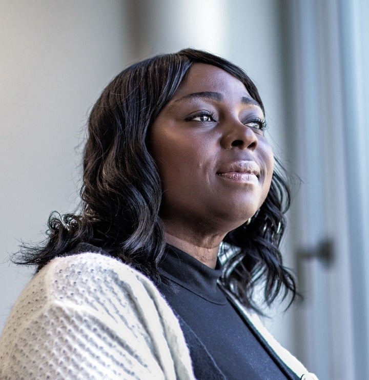 An asian woman standing on the balcony overlooking the city