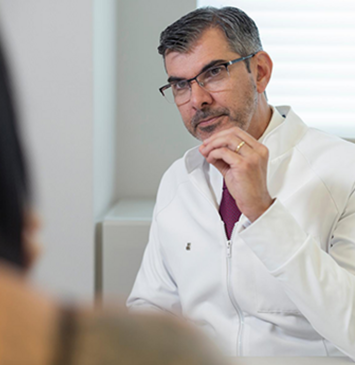 Doctor sitting in a chair and listening to his patient