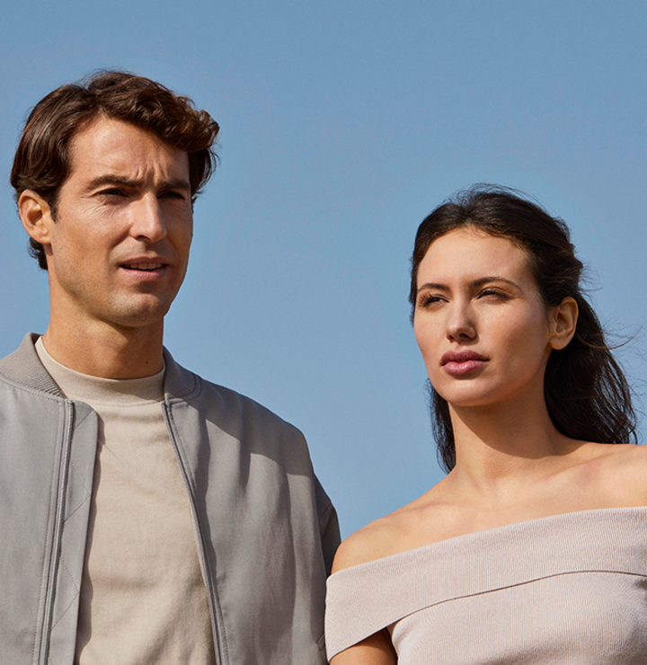 A close-up picture of a man and woman looking the opposite directions