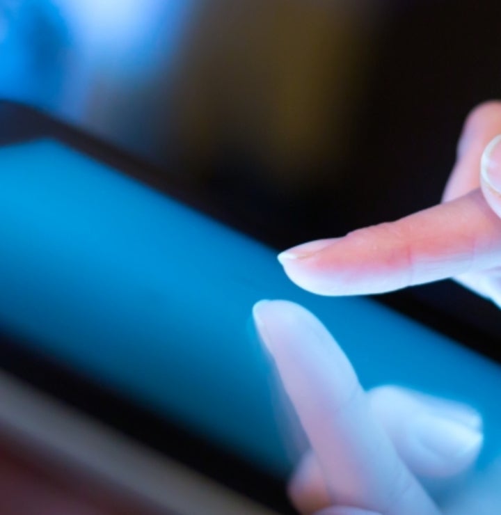 Person clicking on iPad