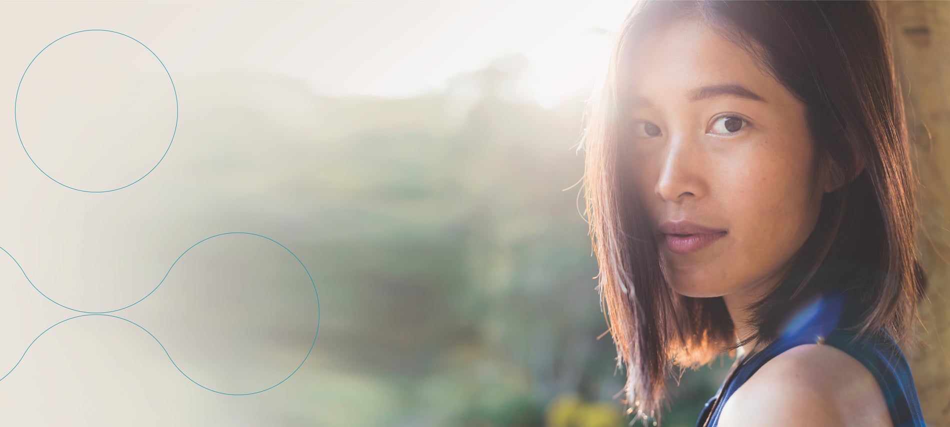 Girl with dark hair turns her head to look at the camera